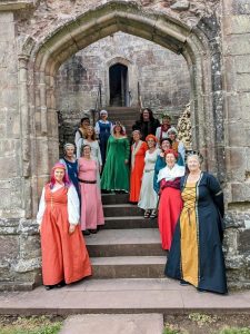 ladies in colourful robes standing on church entrance steps